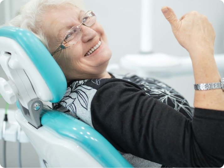 Patient smile after dentures treatment in Mold